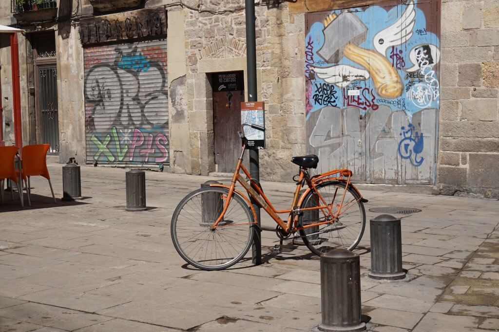 A bike leaning against a lamp post Old City, Barcelona